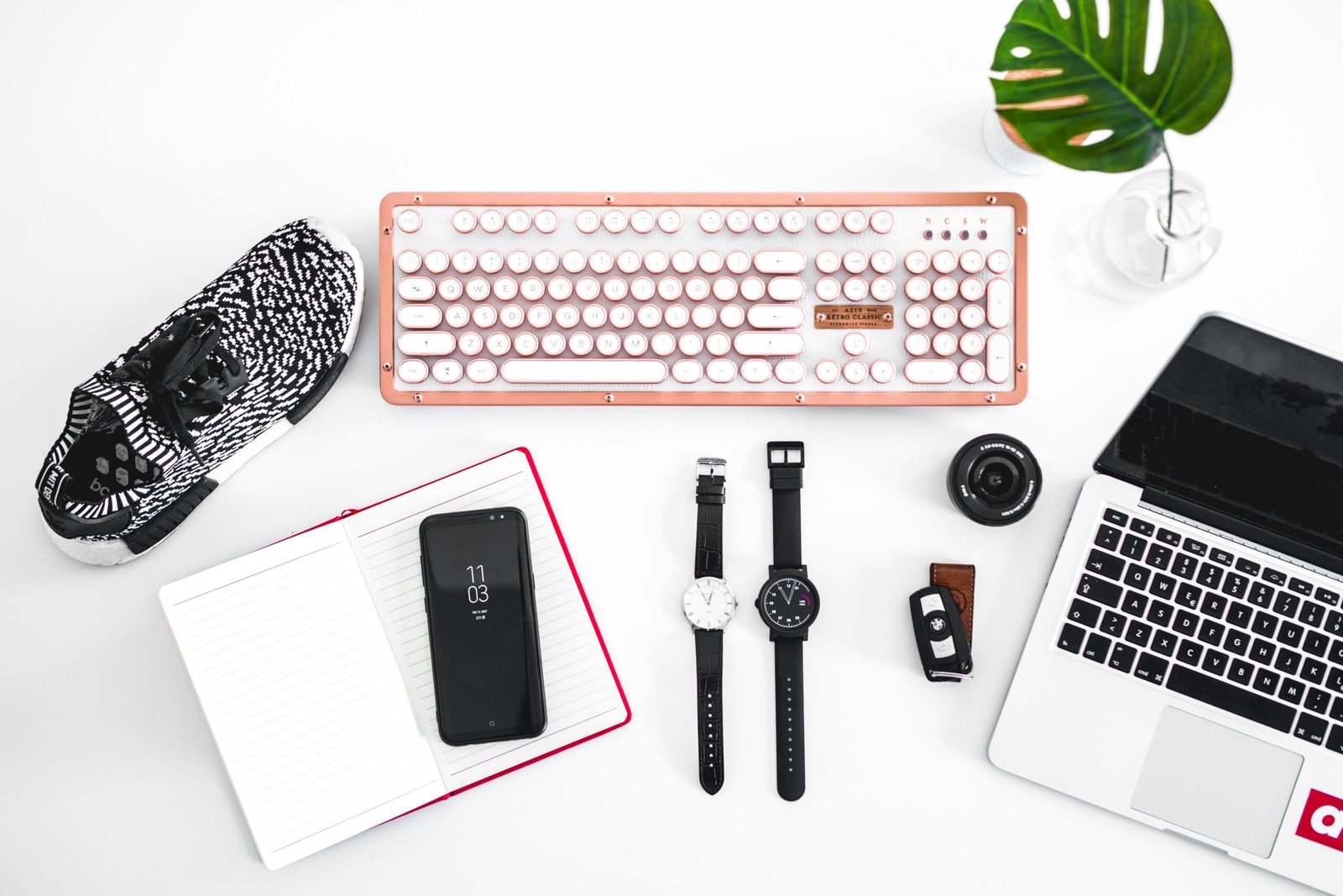 laptop computer beside analog watches on table